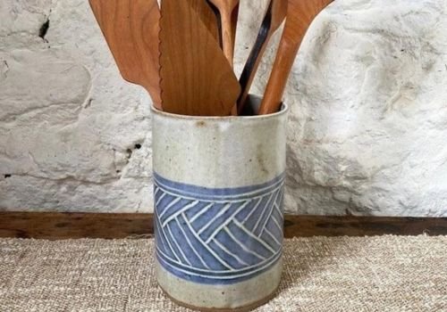 Handmade ceramic utensil crock with textured blue pattern holding wooden kitchen utensils, created during the Wine Bottle Chillers & Utensil Crock clay workshop at the Artist Outpost in Ocean Beach.