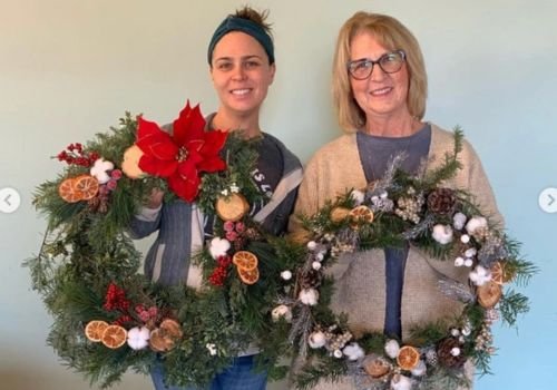 Handmade winter wreaths with greenery, dried citrus, pinecones, and seasonal accents from the Wreath Making Workshop at The Artist Outpost in San Diego